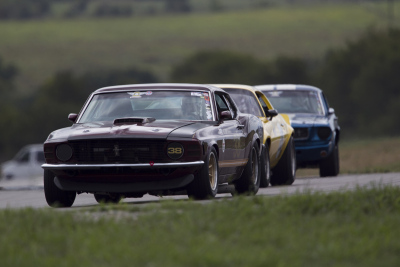Dan Haynes in his 1969 Ford Mustang Boss 302 leads Mark Hannifin and Bobby Whitehead at ECR
