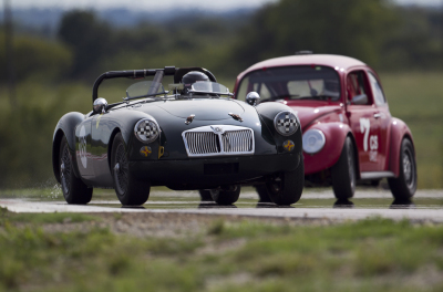 186 Lou Marchant in her MGA holding off 7 Bob Pinkston in his 1966 VW Beetle at Turn 15