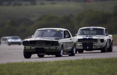 19 Jeff Neathery in his 1966 Ford Mustang Coupe holds off 18 Phil Mulacek in his 1966 Ford Shelby GT350
