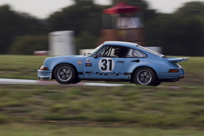 Seth Higgins carries the inside wheel in his 1973 Porsche 911 RSR